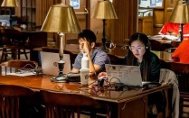 Photo of students studying in the Austin Flint Main Reading Room. 