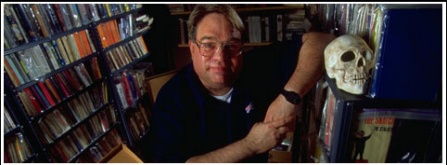 Photo of George Kelley in the stacks. 