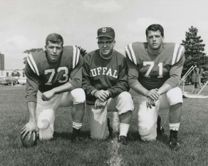 Black and white photo of UB football players Gerry Philbin and Kevin Brinkworth with line coach Buddy Ryan during the 1961-1962 season. 