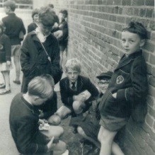 British schoolchildren eagerly discussing and exchanging cards. 