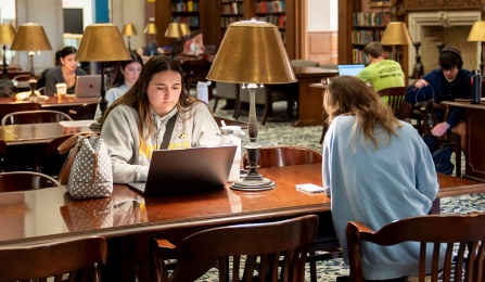 Students studying in Abbott Library's Austin Flint Reading Room. 