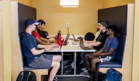 Students studying in a study booth on the third floor of Silverman Library. 
