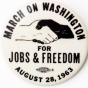 Button with a white and black hand shaking "March on Washington for Jobs and Freedom, August 28, 1963". 