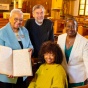 Four people holding up a record in St. Philip’s Episcopal Church. 