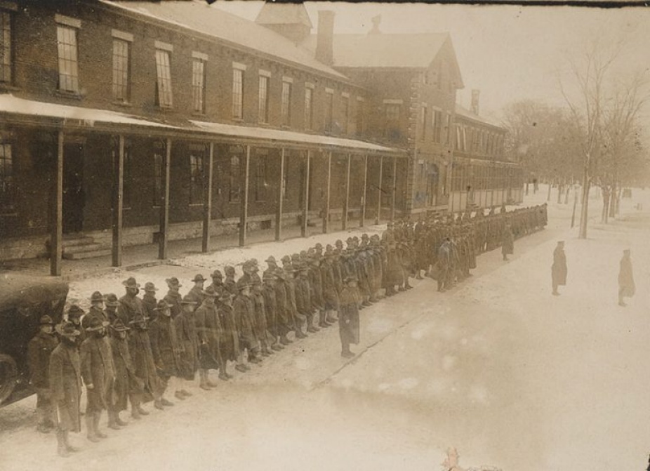 In black and white, the United States of America General Hospital Number 4. Quartermaster and Medical Detachment in front of the hospital building. 