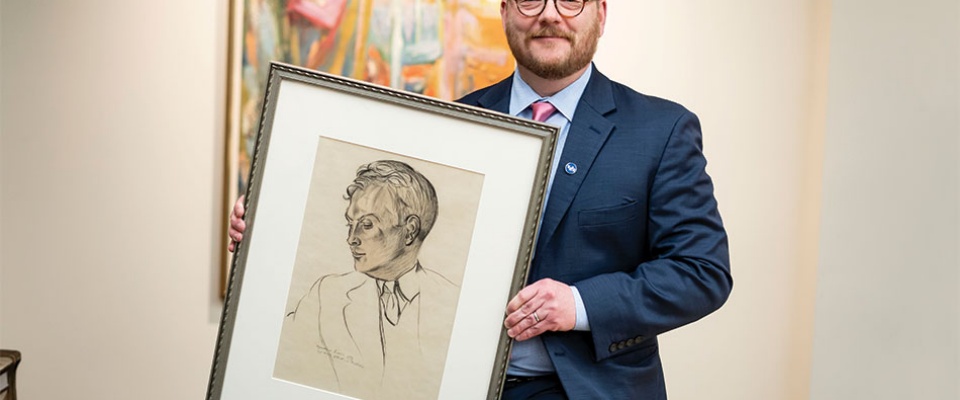 James Maynard holds a 1939 drawing of Charles Abbott by artist and writer Wyndham Lewis in Special Collections. 