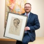 James Maynard holds a 1939 drawing of Charles Abbott by artist and writer Wyndham Lewis in Special Collections. 