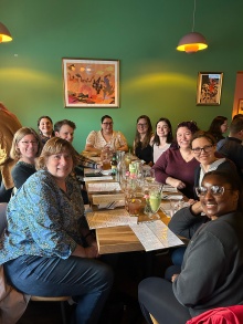 Health Sciences team poses for a photo while seated at dinner. 